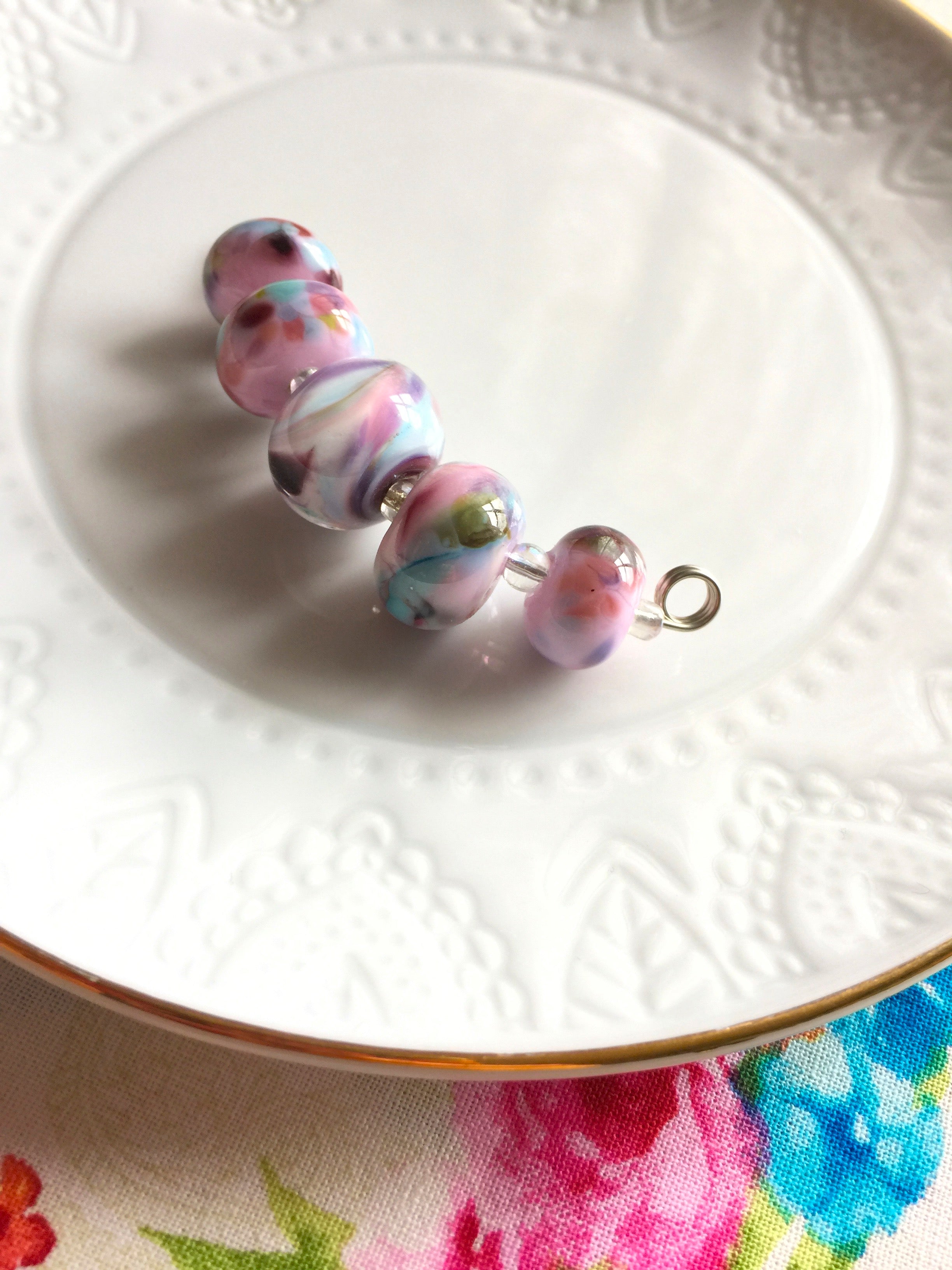 Set of 5 Handcrafted Lampwork Glass Beads in shades of Pink, Blues, Violet with spots and swirls. Perfect for crafting and jewelry making.