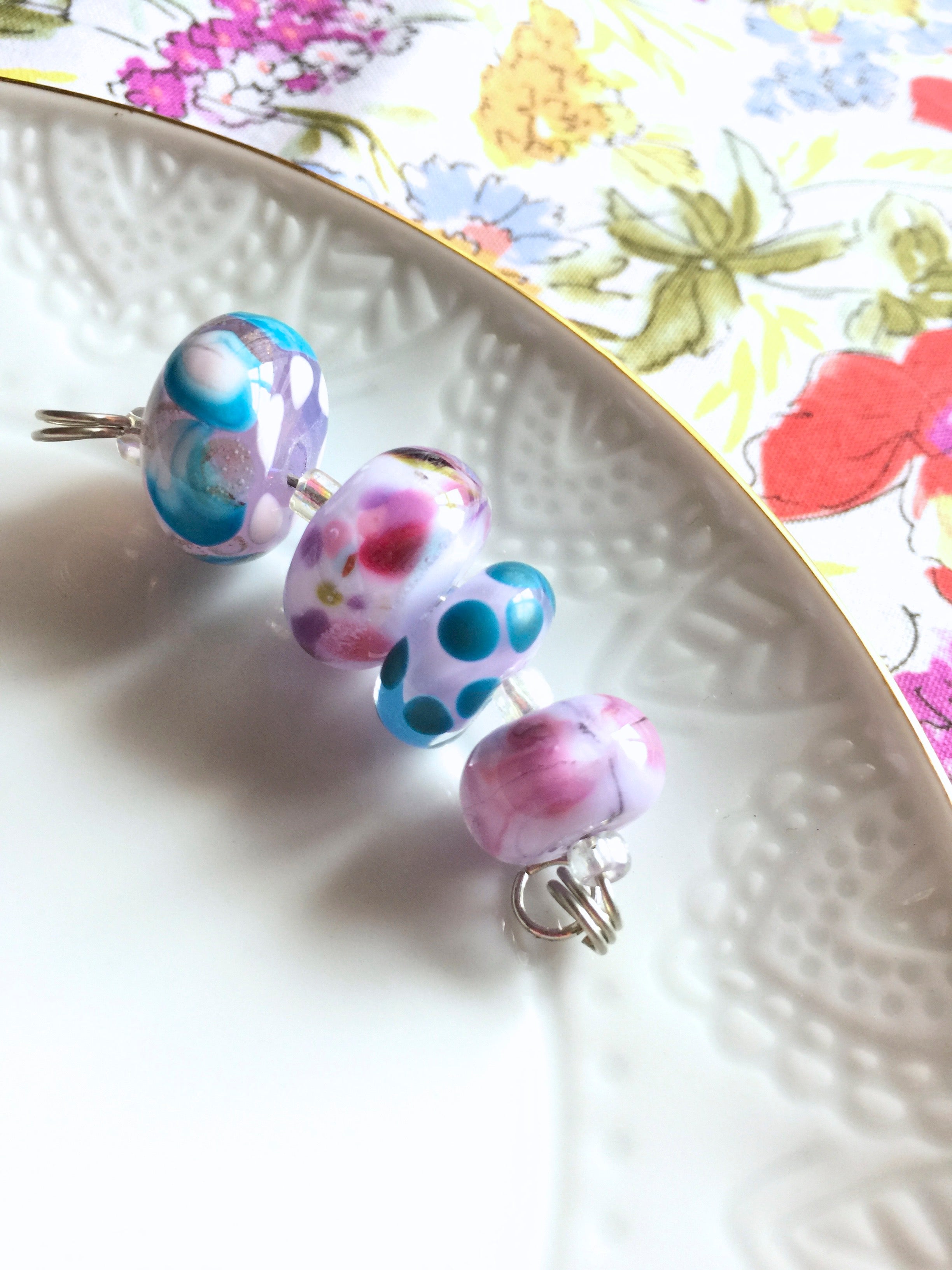 Set of 4 Handcrafted Lampwork Glass Beads in shades of Pink, Blues, Violet with spots and swirls.