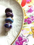 Set of 4 Funky and Unique Handcrafted Lampwork Glass Beads in purples and blues.