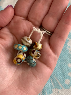 Set of 6 Handcrafted Lampwork Glass Beads in ivory, turquoise, browns, and golden yellow.